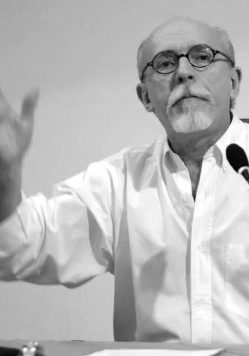Retrato de Luiz Fernando Dias Duarte, de terno e gravata, em uma conferência.